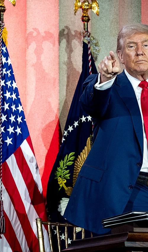 Donald Trump, en el podio con el sello presidencial y las carpetas de las órdenes ejecutivas que acaba de firmar, en la Cumbre de IA de la Casa Blanca, julio de 2025